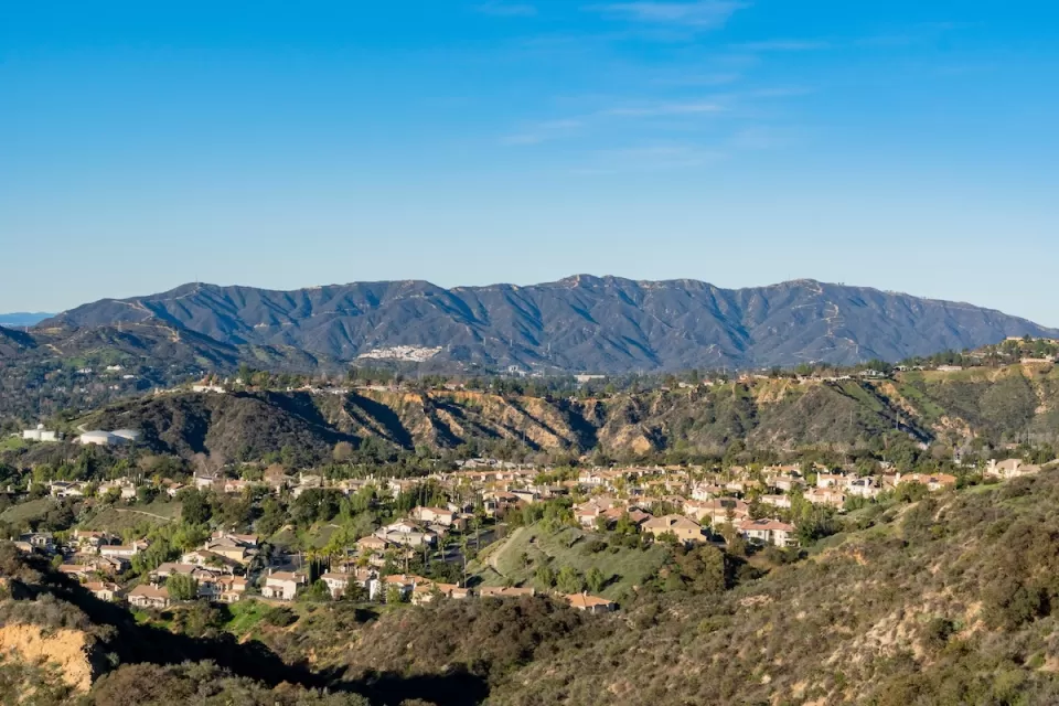 Homes in Altadena, California with mountains in background on a sunny day.
